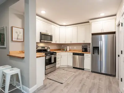 Kitchen with white cabinetry and stainless steel appliances at 4632 McPherson (Historic Haven)