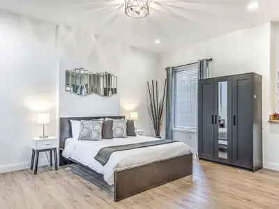 Studio bedroom with king bed and mirrored wardrobe at 4632 McPherson (Hidden Gem)