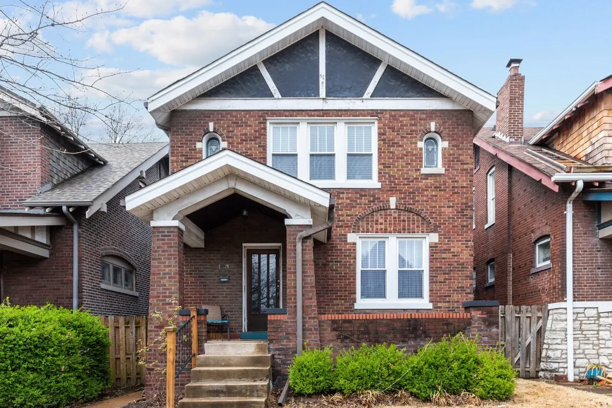 Brick front exterior and covered porch of Forest Park Oasis at 1135 S Kingshighway Blvd